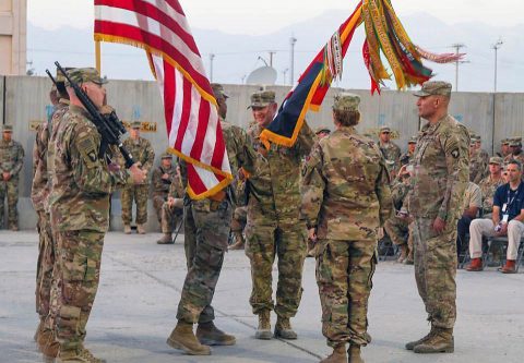 Command Sgt. Maj. Anthony McAdoo passes the Brigade guidon to the outgoing Brigade Commander Colonel Stanley J. Sliwinski during a change of command ceremony at Bagram Airfield, Afghanistan, Aug. 26. The change of command ceremony represents the transfer of responsibility and authority from the outgoing commander, Col. Stanley J. Sliwinski to Col. Stephanie A. Barton. (Staff Sgt. Caitlyn Byrne Public Affairs)