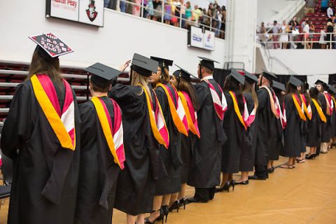  Austin Peay graduate students stand during commencement after receiving their graduate hoods. (Kim Balevre, APSU)