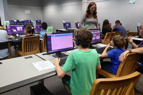 Northeast High School’s Bridget Cloud, standing, is founded and leads Clarksville Junior Coders. “We'll be working on something, and the kids will get off track,” she said. “That's what's so cool is they'll get off track, and they'll find something else, and they'll call me over, and we'll get all excited together.” (Dr. James Cloud, APSU)