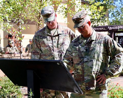 Fort Campbell Warrior Transition Battalion cadre Staff Sgt. Jason Wilkins and 1st Sgt. Steven Peters read names on a plaque memorializing the WTB’s fallen Soldiers following a breakfast for Gold Star Families and an Eagle Warrior Memorial Garden rededication ceremony Sept. 13. (U.S. Army photo by Maria Yager)