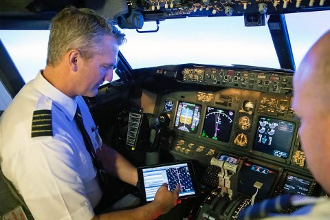 Bret Peyton, 737 captain and Alaska Airlines director of fleet technology support, tests NASA’s Traffic Aware Planner (TAP) software on the flight deck. (Alaska Airlines/Ingrid Barrentine)