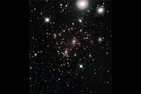 This image shows a massive galaxy cluster embedded in the middle of a field of nearly 8,000 galaxies scattered across space and time. This "galaxies galore" snapshot is from a new Hubble Space Telescope survey to boldly expand its view by significantly enlarging the area covered around huge galaxy clusters previously photographed by Hubble. (NASA, ESA, A. Koekemoer (STScI), M. Jauzac (Durham University), C. Steinhardt (Niels Bohr Institute), and the BUFFALO team)