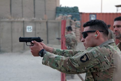 German army Maj. Andreas Mehlhron, a field artillery officer, and officer in charge of the “Schutzenschnur” event, coaches Spc. Anthony Addcock, a motor transportation specialist with the 101st Resolute Support Sustainment Brigade, while he fires the Koch P8 Pistol at Maholic Range on Bagram Airfield, Afghanistan, September 14th, 2018. (Spc. Alexes Anderson, 101st Airborne Division (AA) Sustainment Brigade Public Affairs)