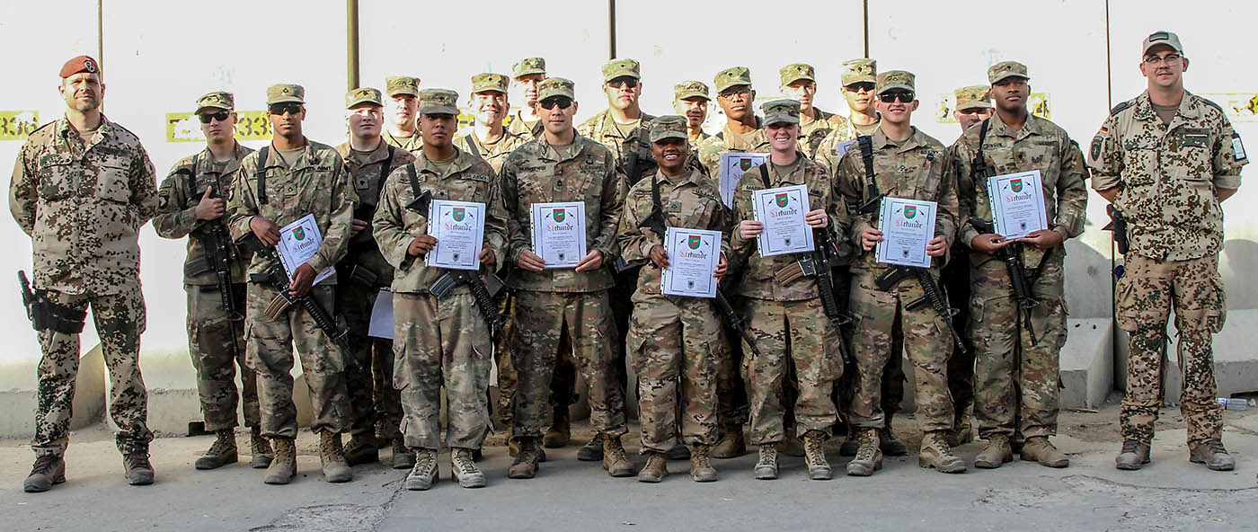 Soldiers of the 101st Resolute Support Sustainment Brigade proudly hold up their certificates of achievement after being recognized in an award ceremony for earning their German proficiency marksmanship badge on Bagram Airfield, Afghanistan, September 14th, 2018. (Spc. Alexes Anderson, 101st Airborne Division (AA) Sustainment Brigade Public Affairs)
