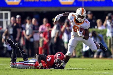 Tennessee Volunteers running back Ty Chandler (8) tries to escape a tackle by Georgia Bulldogs defensive back J.R. Reed (20) during the first half at Sanford Stadium. (Dale Zanine-USA TODAY Sports)