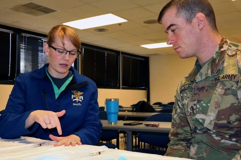 1st Lt. Megan Smith instructs Pfc. Shane Sheffield of Young Eagle Medical Home on administering a digital nerve block at monthly medic training. Physician assistants are responsible for training their medics, so Blanchfield's IPAP Phase II directors incorporate medic training under the supervision of their instructors to prepare the future physician assistants. (U.S. Army photo by Maria Yager)