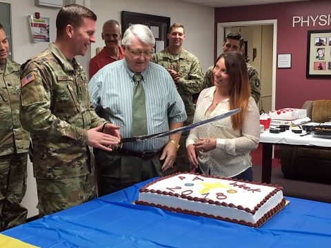 Fort Campbell's most senior physician assistant Terry Davis, (center) assigned to Blanchfield, newest physician assistant 1st Lt. Elizabeth McGrattan, assigned to the Tennessee National Guard, and the hospital's newest Interservice Physician Assistant Program Phase II student 1st Lt. Thomas Carroll cut a cake Oct. 11 at a luncheon and networking event at the hospital in honor of PA Week. (U.S. Army photo by Laura Boyd.)