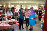 Clarksville Mayor Kim McMillan cuts a ribbon Friday to dedicate The Shoppe, a new thrift store at the Ajax Turner Senior Citizens.