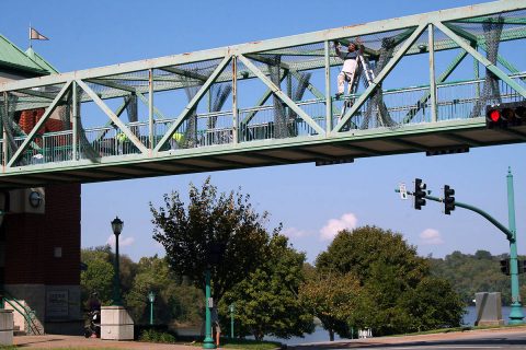 Workers from Pride Concrete LLC work Monday on the Clarksville Riverside Drive Pedestrian Overpass. The painting project, which will require some lane changes, is expected to begin October 15th.