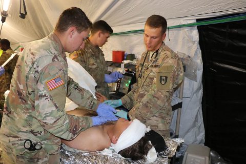 Soldiers from the 586th Field Hospital treat a simulated casualty in their new field hospital during a field exercise Oct. 16. The training was the first time the unit was able to break out its new 148-bed field hospital platform since transitioning from the 86th Combat Support Hospital to the Army's new modular field hospital platform. To date the Army has transitioned three of 10 combat support hospital's to the new design. (U.S. Army photo by Maria Yager)