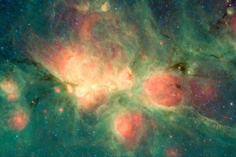 The Cat's Paw Nebula, imaged here by NASA's Spitzer Space Telescope using the MIPS and IRAC instruments, is a star-forming region that lies inside the Milky Way Galaxy. New stars may heat up the surrounding gas, which can expand to form "bubbles." (NASA/JPL-Caltech) 