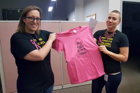 Elizabeth “Ellie” Horton shows off one of the t-shirts with the logo “NO ONE FIGHTS ALONE” #STANDSTRONGELLIE.