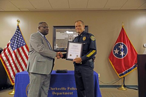 Clarksville Police Chief Al Ansley gives Sergeant John W. Hunt a retirement certificate during Hunt's retirement ceremony at Clarksville Police Headquarters.