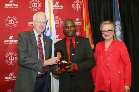 Mike O'Malley, chair of the Austin Peay State University Board of Trustees, and APSU President Alisa White present retired Lt. Gen. Ron Bailey with his award.