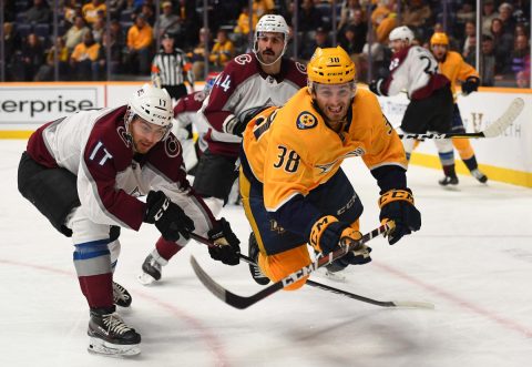 Nashville Predators right wing Ryan Hartman (38) is tripped by Colorado Avalanche center Tyson Jost (17) as he battles for a puck during the third period at Bridgestone Arena. (Christopher Hanewinckel-USA TODAY Sports)