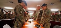 Soldiers of the 101st Resolute Support Sustainment Brigade bow their heads in prayer during the invocation for a prayer dinner. Attendees rejoiced with their unit counterparts through prayer, live music, and scripture teachings at Bagram Airfield, Afghanistan. (1st Lt. Verniccia Ford, 101st Airborne Division (AA) Sustainment Brigade Public Affairs)