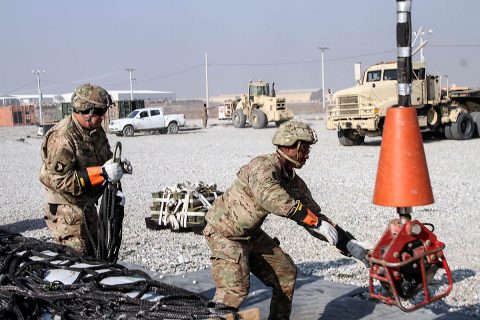 Staff Sergeant Timothy Adams (left), the 101st Special Troops Battalion master driver and sling load team member, works together with Sergeant Eric Greene (right), a native of Columbus, Georgia and a generator mechanic and sling load inspection certification course squad leader for the 101st Resolute Support Sustainment Brigade, on slinging a load of supplies for another forward operating base, on Bagram Airfield, Afghanistan, December 11th, 2018. (Sgt. Caitlyn Byrne, 101st Airborne Division (AA) Sustainment Brigade Public Affairs)