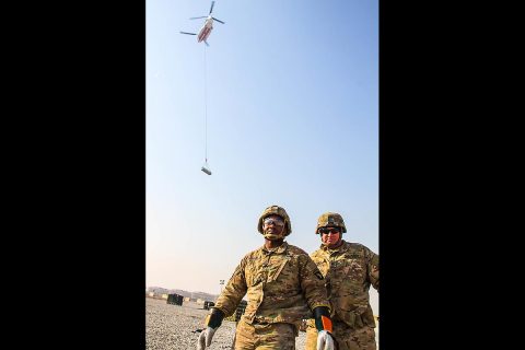 Staff Sergeant Timothy Adams (right), the 101st Special Troops Battalion master driver and sling load team member stands with Sergeant Eric Greene (left), a native of Columbus, Georgia and a generator mechanic and sling load inspection certification course squad leader for the 101st Resolute Support Sustainment Brigade, after completing a successful sling load mission, on Bagram Airfield, Afghanistan, December 11th, 2018. (Sgt. Caitlyn Byrne, 101st Airborne Division (AA) Sustainment Brigade Public Affairs)