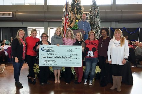 Jackie Harker (center) and the Clarksville Association of Realtors Entertainment Committee presents the check to Terrie Williams (far right).