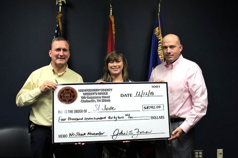 Montgomery County Sheriff John Fuson and Captain Jesse Reynolds presents a check for $4,742 to Jackie Proffit with St. Jude’s.