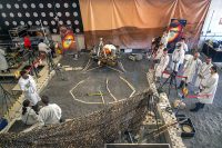 Engineers in Pasadena, California, sculpt a gravel-like material to mimic the terrain in front of NASA’s InSight lander on Mars. Recreating the exact conditions will allow them to practice setting down the lander’s instruments here on Earth before it’s done on Mars. (NASA/JPL-Caltech/IPGP)