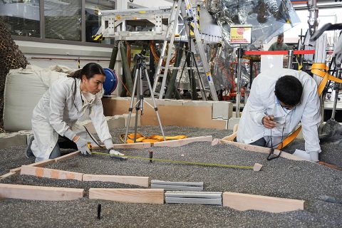 Engineers Marleen Sundgaard (left) and Pranay Mishra measure their test lander's "workspace" -- the terrain where scientists want to set InSight's instruments -- at NASA's Jet Propulsion Laboratory in Pasadena, California. (NASA/JPL-Caltech/IPGP) Engineers Marleen Sundgaard (left) and Pranay Mishra measure their test lander's "workspace" -- the terrain where scientists want to set InSight's instruments -- at NASA's Jet Propulsion Laboratory in Pasadena, California. (NASA/JPL-Caltech/IPGP)