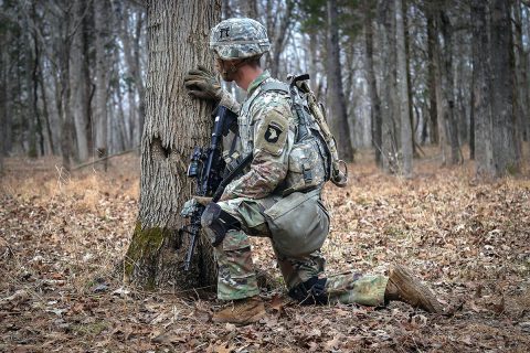 Sgt. David Penney, a Squad Leader with 2nd Battalion, 506th Infantry Regiment, 3rd Brigade Combat Team, 101st Airborne Division, takes cover behind a tree during the battalion-level Live Fire Exercise January 16th. (U.S. Army Photo by Sgt. Aaron Daugherty)