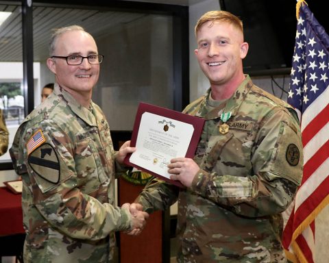 Hospital Commander, Col. Anthony McQueen presents Spc. Robbie Brockman, a practical nursing specialist assigned to the hospital's Mother Baby Unit, with the Army Commendation Medal for Brockman's selection as Blanchfield Army Community Hospital Soldier of the Year at an award ceremony Jan. 17. (U.S. Army photo by Maria Yager)