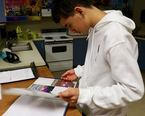 A Northeast Middle School student in Clarksville, Tennessee, reads about a Flat Stanley's visit to the hometown of one Blanchfield Army Community Hospital employee from Hopkinsville, Kentucky. Soldiers and federal service employees from Blanchfield adopted Flat Stanley's from Northeast over the holidays and documented his experiences for the students to read. (Maria Yager, BACH)