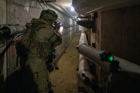 An infantryman with 1st Battalion, 187th Infantry Regiment, 3rd Brigade Combat Team, 101st Airborne Division (Air Assault) fires at notional opposing forces while clearing a tunnel system under the Muscatatuck Urban Training Center at Camp Atterbury, Indiana on Dec. 7, 2018. The tunnel system connected all the buildings. (Sgt. Patrick Kirby, 40th Public Affairs Detachment) 