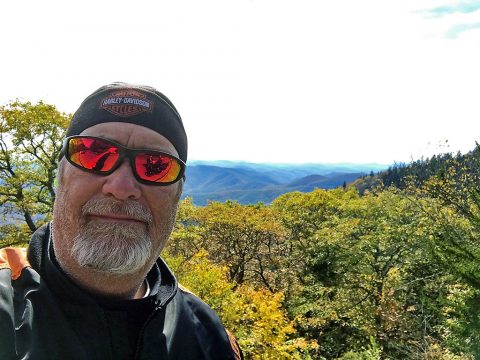 Hank with his Motorcycle in the Mountains