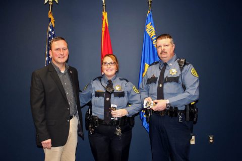 Montgomery County Sheriff John Fuson congratulates Shanna Grice and Derrick Carroll on their promotion.