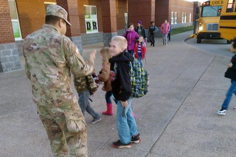 Spc. Raul Hernandez, an infantryman with C Co., 1st Battalion, 187th Infantry Regiment, 3rd Brigade Combat Team, greets South Christian students as they arrive for school in the morning. (U.S. Army Photo by 1st Lt. John Radigan)