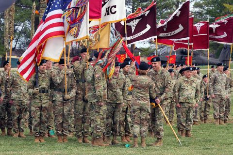 Maj. Gen. Andrew Poppas passes the "Screaming Eagle" colors to Lt. Gen. Laura Richardson, acting commanding general for U.S. Forces Command, relinquishing command of the 101st Airborne Division (Air Assault), Feb. 14, at Fort Campbell, Kentucky. Poppas was succeeded by Maj. Gen. Brian Winski during the ceremony, as the 47th "Eagle 6." (Spc. Beverly Roche, 40th Public Affairs Detachment)