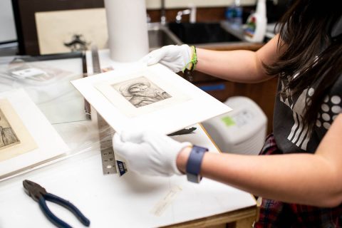 Tolleson holds one of the Legros drypoints she found. Tolleson holds one of the Legros drypoints she found.