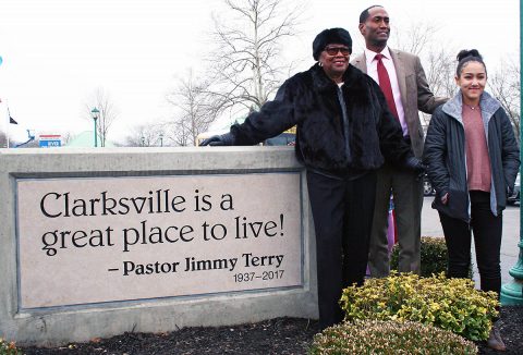 Servella Terry, wife of the late Pastor Jimmy Terry; his son, Jimmy Terry, and his daughter, Londyn; gather around the monument unvieled Friday.