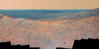 This May 14, 2014, scene from the Pancam on NASA’s Mars Exploration Rover Opportunity catches “Pillinger Point,” on the western rim of Endeavour Crater, in the foreground and the crater’s eastern rim on the horizon. (NASA/JPL-Caltech/Cornell Univ./Arizona State Univ.)