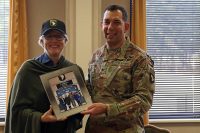 Col. Joseph E. Escandon, 2nd Brigade Combat Team, 101st Airborne Division (Air Assault) commander, presents Helen Ayer Patton, granddaughter of the famed Gen. George S. Patton, Jr. who commanded the U.S. Third Army in France and Germany following the Allied invasion of Normandy, with a framed photo commemorating her visit to Fort Campbell, Feb. 25. (Sgt. James Griffin, 1st Brigade Combat Team Public Affairs)