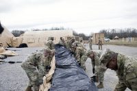 Soldiers from the Support Operations (SPO) section of the 1st Theater Sustainment Command unfold a large Airbeam tent Feb. 14, 2019 at Fort Campbell, KY. The tent is part of the unit’s Early Entry Command Post. (Master Sgt. Jonathan Wiley)