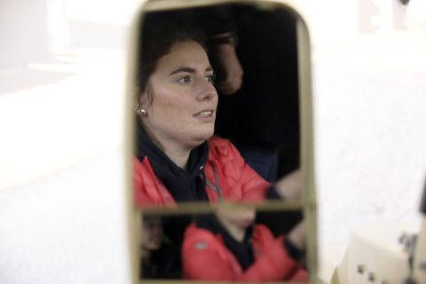 Agathe Moocie feels the pressure as she drives through virtual Afghanistan terrain in the Reconfigurable Vehicle Tactical Convoy Trainer Simulator, at Fort Campbell, March 12. Moocie is a French student visiting Fort Campbell for the “Memory and Gratitude Tour” to honor the day the 101st Airborne Division liberated Carentan from Nazi-German forces, in 1944. (Sgt. 1st Class Katrina Craig)