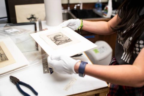 Katherine Tolleson holds Austin Peay State University’s Legros print titled “The Sailor.” (APSU)