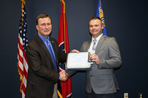 Montgomery County Sheriff John Fuson congratulates Bryan DeRose on his promotion.