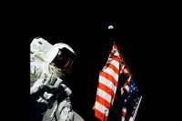 Geologist-Astronaut Harrison Schmitt, Apollo 17 Lunar Module pilot, is photographed next to the American Flag during NASA’s final lunar landing mission in the Apollo series — a mission that included an instrument developed by Goddard scientist Otto Berg. The photo was taken at the Taurus-Littrow landing site. The highest part of the flag appears to point toward planet Earth in the distant background. (NASA)