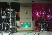 JPL scientists used the “oven” (center) to heat a mixture of hydrogen and carbon monoxide and subject it to UV radiation, generated by a hydrogen gas discharge lamp. The lamp radiates both visible light (the pink glow) and UV light, which enters the gas container inside the oven via a window on the right side. (NASA/JPL-Caltech)