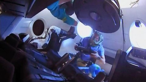 Expedition 58 crew members enter the SpaceX Crew Dragon for the first time. They are wearing protective gear to avoid breathing particulate matter that may shaken loose during launch. (NASA) Expedition 58 crew members enter the SpaceX Crew Dragon for the first time. They are wearing protective gear to avoid breathing particulate matter that may shaken loose during launch. (NASA)