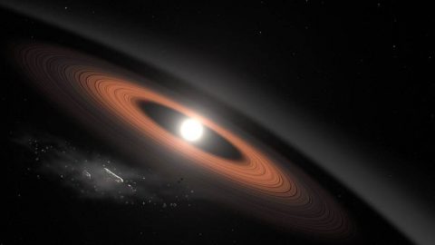 In this illustration, an asteroid breaks apart under the powerful gravity of LSPM J0207+3331, a white dwarf star located around 145 light-years away. Scientists think crumbling asteroids supply the dust rings surrounding this old star. (NASA’s Goddard Space Flight Center/Scott Wiessinger)