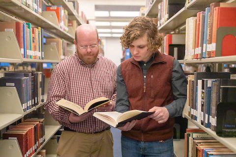 Austin Peay State University professor Dr. Kevin Harris and student Nick Foreman review expert literature at the library. (APSU)