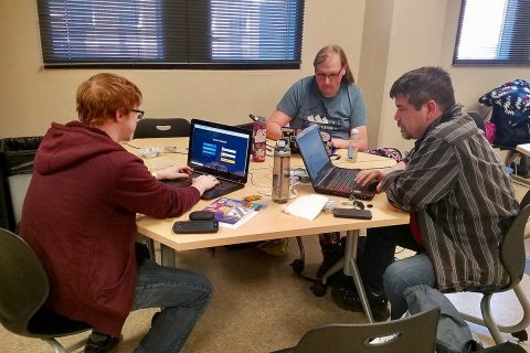 From the left, Austin Peay State University students Aidan Murphy, Susan Kersten and Nathan Nickelson work on their hacks.