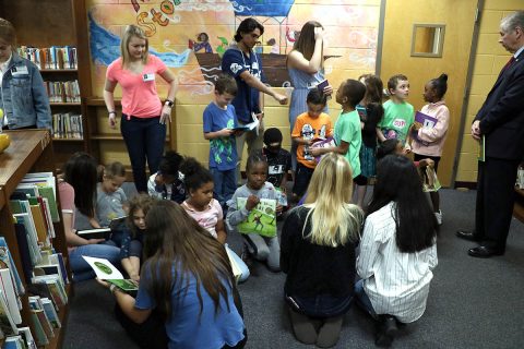 Several members of the Clarksville Mayor’s Youth Council sit to read with Norman Smith Elementary School students following the donation of more than 700 books to the school. The council began a book drive last September and recently began distributing the collected books to a few elementary schools in the Clarksville-Montgomery County School System. 