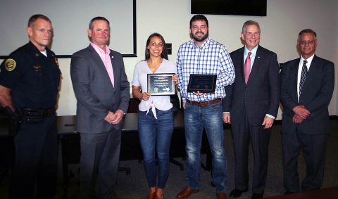 Ashley Arrington and Benjamin Tribbett, with plaques, were honored by their peers at the E-911 Center as 2019 Co-Workers of the Year. The plaques were bestowed Monday by, from left, Clarksville Police Chief Al Ansley, Montgomery County Mayor Jim Durrett, City of Clarksville Mayor Joe Pitts and E-911 Center Director Brian Hitchcock.